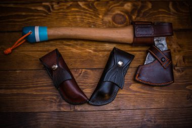 Doğal ahşap dokuda deri kılıflı ahşap saplı bir balta..