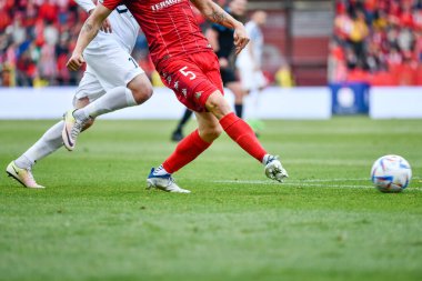 LODZ, POLAND - OCTOBER 16, 2022: Football match Polish PKO Ekstraklasa between Widzew Lodz vs KGHM Zaglebie Lubin 3:0. Detail of players legs and ball.