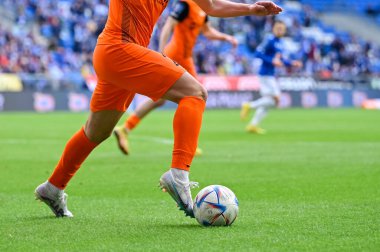 POZNAN, POLAND - FEBRUARY 19, 2023: Football match Polish PKO Ekstraklasa between Lech Poznan vs KGHM Zaglebie Lubin 1:2. Detail of footballer's legs and ball.