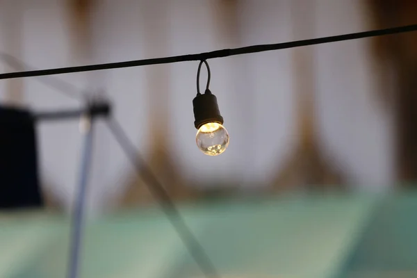 A light bulb hanging on the railing, Hanging bulb set with multiple lights.