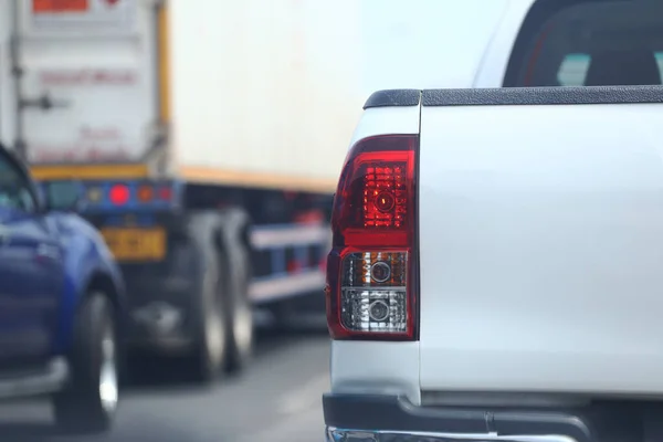 The taillight of a braking car on the road and a blurred image behind another car, Copy space for copying and inserting details of your product or object in your presentation.