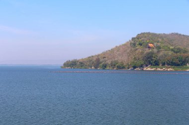 View of Ubonrat Dam during the day with sunlight and clear weather, Large dam in Isaan Thailand is located in Khon Kaen Province. clipart