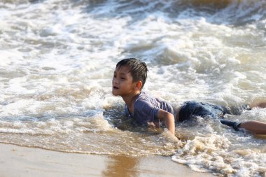 Genç bir çocuk güneşli bir günde okyanus dalgalarında oynamanın eğlencesini yaşıyor. Unutulmaz bir plaj gezisi sırasında çocukluğun kaygısız ruhunu somutlaştırıyor..