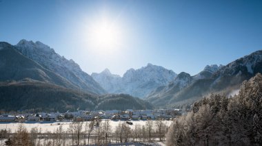 Slovenya 'dan Kranjska Gora kışın karla kaplanırken, arkada Julian Alps ve Triglav Ulusal Parkı yer alıyor