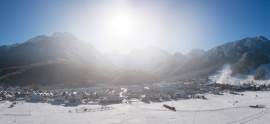 Panorama of skiing town Kranjska Gora in Slovenia covered in snow on a cold sunny winter morning.
