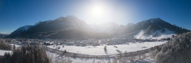 Panorama of skiing town Kranjska Gora in Slovenia covered in snow on a cold sunny winter morning.