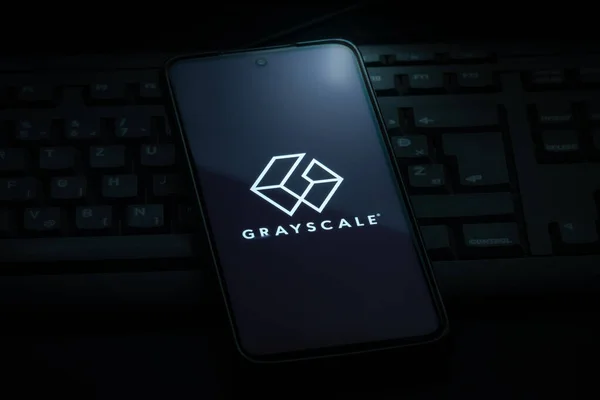 Ljubljana, Slovenia - 21 January 2023: Grayscale investing logo on smartphone screen laying on computer keyboard