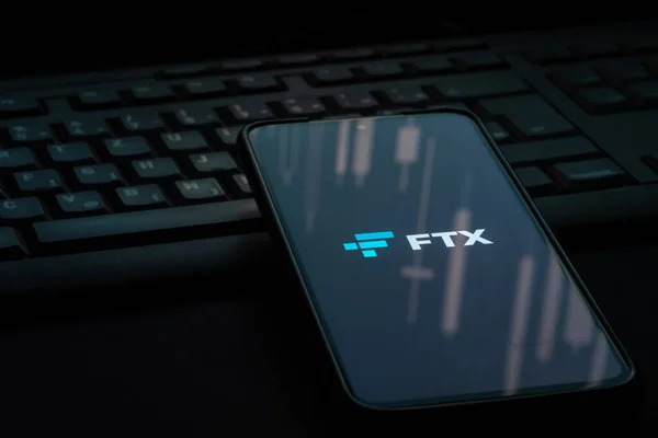 Ljubljana, Slovenia - 21 January 2023: FTX crypto exchange logo on smartphone screen laying on computer keyboard
