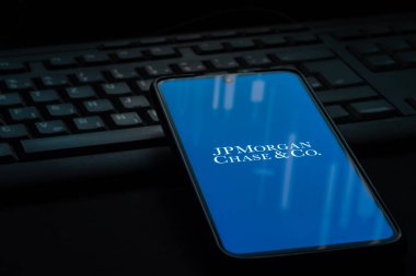 Ljubljana, Slovenia - 21 January 2023: JPMorgan Chase bank logo on smartphone screen laying on computer keyboard