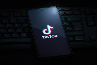 Ljubljana, Slovenia - 21 January 2023: TikTok logo on smartphone screen laying on computer keyboard