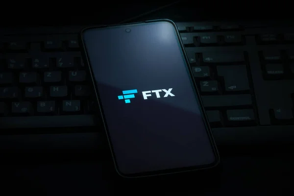 stock image Ljubljana, Slovenia - 21 January 2023: FTX cryptocurrency exchange logo on smartphone screen laying on computer keyboard