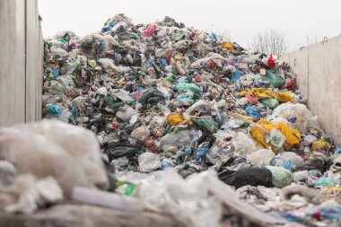 Landfill with trash and garbage polluting environment waiting to recycle