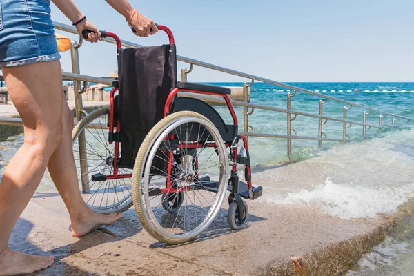 Accessible beach with wheelchair with ramp for persons with disability