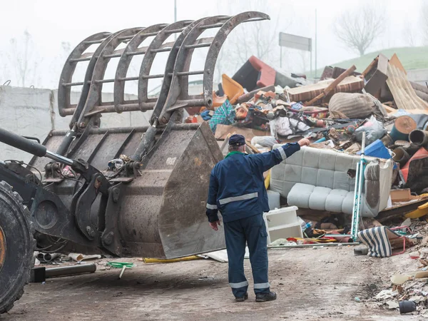 Landfill Worker Directing Skid Steer Loader Garbage Heap Rear View — 图库照片