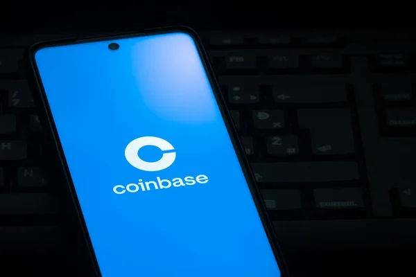 stock image Ljubljana, Slovenia - 21 January 2023: Coinbase cryptocurrency exchange logo on smartphone screen laying on computer keyboard