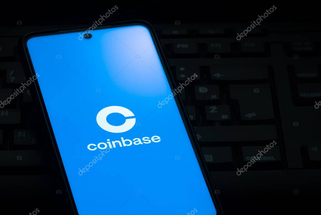Ljubljana, Slovenia - 21 January 2023: Coinbase cryptocurrency exchange logo on smartphone screen laying on computer keyboard