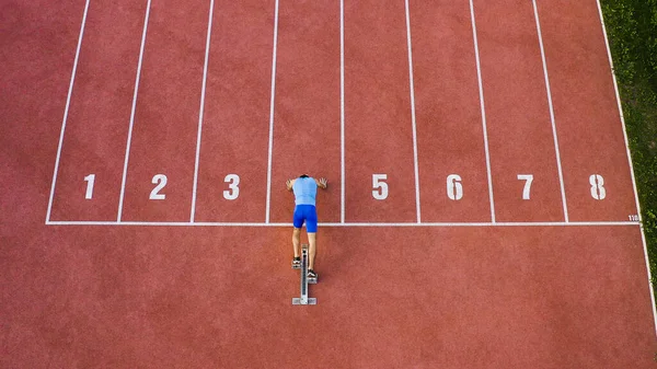 Caucasian Male Sprint Runner Alone Athletic Track Taking Starting Position — Stock Photo, Image