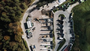 Landfill site, a pile of stinky different junk disposal in the concrete section for unsorted waste materials