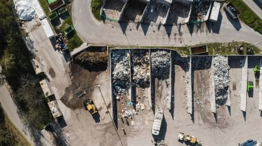 Landfill site, a pile of stinky different junk disposal in the concrete section for unsorted waste materials