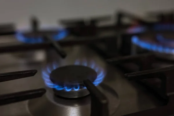 Gas burner on kitchen stove for cooking with fire, energy concept
