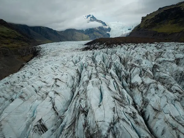 stock image Across glacier crevices, unique and powerful surface of ice caps, Icelandic natural attraction, aerial close up shot. Nature wonder and travel concepts.