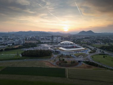 Ljubljana Stozice, Slovenia - 19 June 2023: Drone panorama of the football stadium and arena at sunset. Aerial view clipart