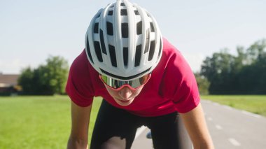 Woman road cycling on race bike outdoor in nature