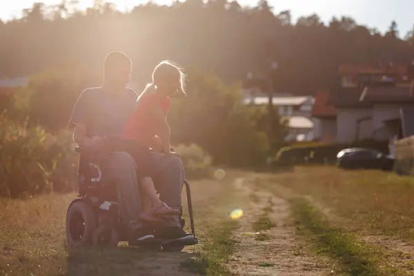 stock image Father with disability and his children leisurely walk through natural rural surroundings and enjoy each others company. Family concept.