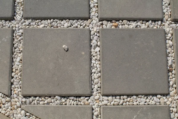 セメントレンガの正方形の石の床と白い岩の背景 通りの底の舗装されたタイルの質感 — ストック写真