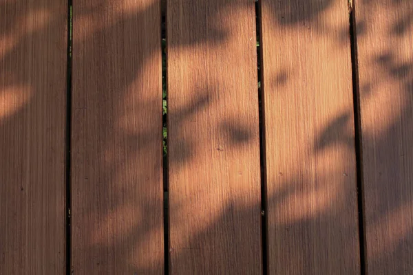 stock image Wooden wood floor with morning sunlight and shadow background. Outdoor exterior. Wooden surface with copy space