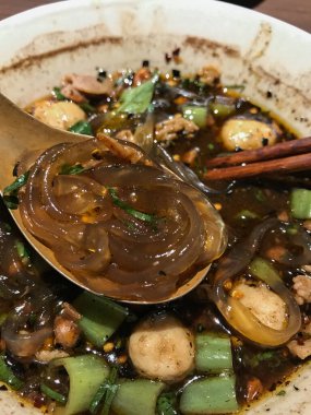 Thai Boat noodles served with vegetable and thicken soup with stewed pork , pork ball ,Braised pork and liver pork. Thai food concept.