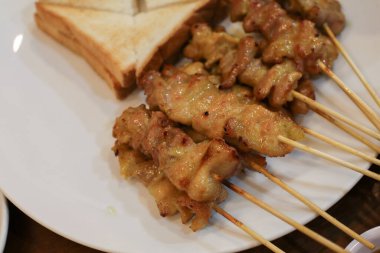 Pork Satay, Grilled pork served with peanut sauce or sweet and sour sauce. Thai street food that is delicious and popular among Thai people And tourists.