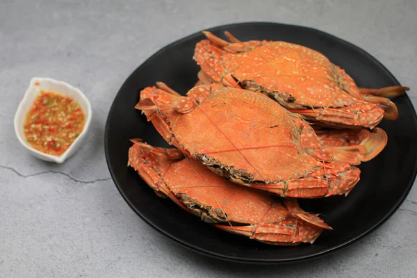 Steamed crab eating with spicy chili seafood dipping sauce. Thai style, seafood. Texture background with copy space for text