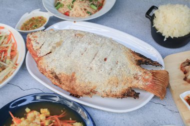 Fish grilled salt. Thai foods style placed. Thai dipping spicy sauce and green vegetables. Low fat and healthy food in Thailand.