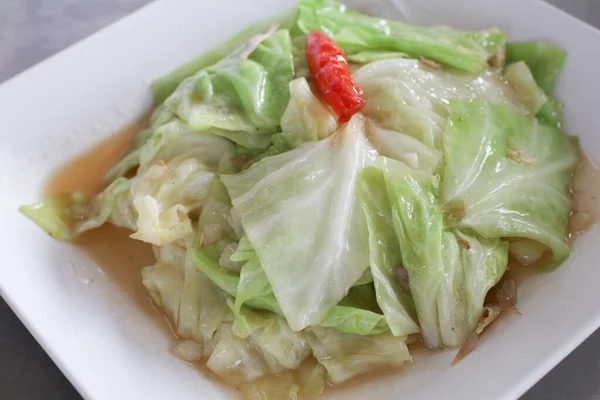 stock image Stir-Fried Cabbage with Fish Sauce on White Square Plate on white background. Homemade Asian food.