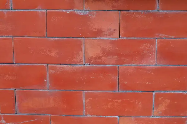 İç veya dış tasarım arka planı için kırmızı kahverengi duvar dokusu. Stonewall Surface 'in canı sıkkın. Retro House Cephesi.