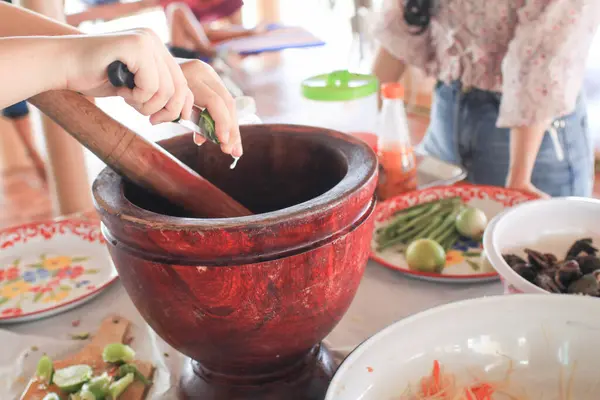 stock image Woman cooking SomTum or papaya salad with ingredients pepper, tomato, lemon and garlic is traditional Thai food.