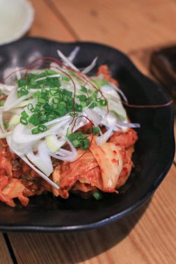 Kızarmış domuz eti, kimchi ve siyah tabakta sebze. Kore yemeği tarzı..