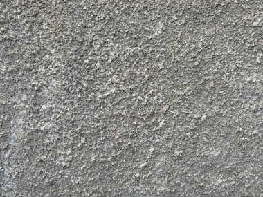 Parlak dokusu ve güneş ışığıyla gri bir beton duvarın arka planı. Yüksek kalite fotoğraf