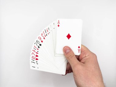 Beyaz erkek eli beyaz arka plan görüntüsüne odaklanmış beyaz plastik poker kartlarını gösteriyor. Yüksek kalite fotoğraf