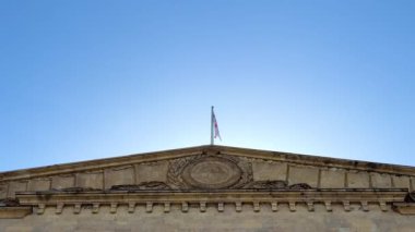 AB ve Gürcistan bayrakları binanın cam cephesinin arka planında dalgalanıyor. Devlet egemenliğinin kaybına giden yol. Yüksek kalite 4k görüntü