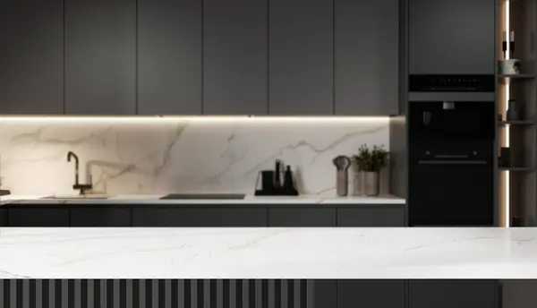 Mockup space on a luxury white marble tabletop with a blurred modern minimal gray kitchen