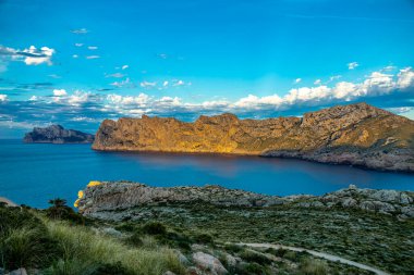 Evening hike to Puig de I'guila at the gates of the bay of Cala Sant Vicen on the Balearic island of Mallorca - Spain clipart