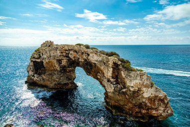 Short but beautiful hike to the Es Ponts rock gate and the coastal town of Santany in the south of the Balearic island of Mallorca - Spain