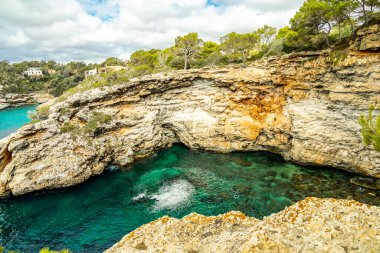 Short but beautiful hike to the Es Ponts rock gate and the coastal town of Santany in the south of the Balearic island of Mallorca - Spain