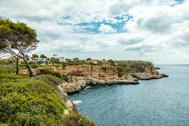 Short but beautiful hike to the Es Ponts rock gate and the coastal town of Santany in the south of the Balearic island of Mallorca - Spain