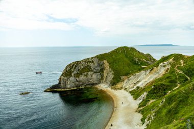 Travelling on the South West Coast Path between Lulworth Cove and Durdle Door near Lulworth - United Kingdom clipart