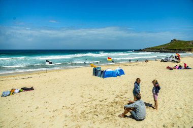 A relaxing day on the beach in front of St Ives Bay in beautiful Cornwall - United Kingdom clipart