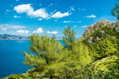 Hike to the Talaia d'Alcdia mountain and viewpoint with a fantastic view of the bay of Alcdia on the Balearic island of Mallorca - Spain clipart