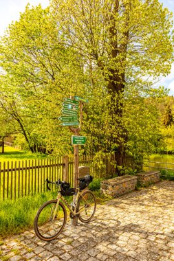 Travelling by bike on the 1st Werratal Cycle Route stage from the source of the Werra near Wernshausen to Werratal near Hrschel - Thuringia - Germany clipart